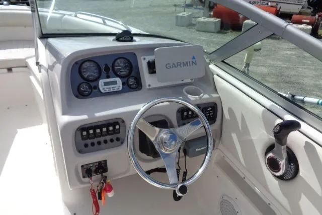 Slide: The Image of 2005 Robalo R227 Dual Console boat dashboard with Garmin navigation system. - 15