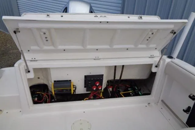 Slide: The Image of 2005 Robalo R227 Dual Console boat battery compartment with wiring and switches. - 18