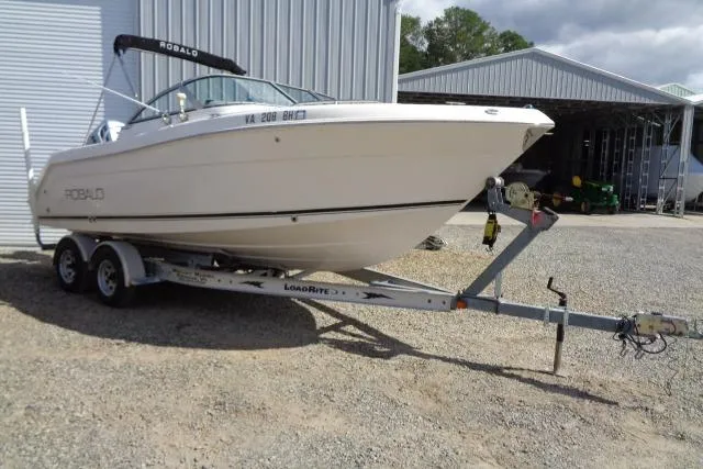 Slide: The Image of 2005 Robalo R227 Dual Console boat on trailer outside metal building. - 4