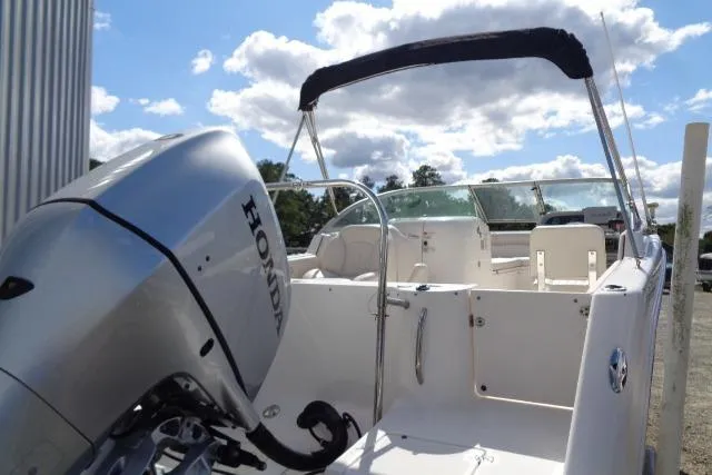 Slide: The Image of 2005 Robalo R227 Dual Console boat with Honda outboard motor, under a sunny sky. - 5