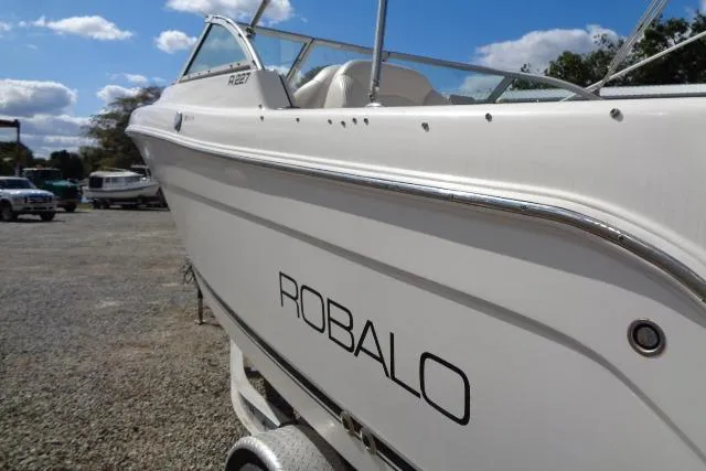 Slide: The Image of 2005 Robalo R227 Dual Console boat on trailer, side view under blue sky. - 8