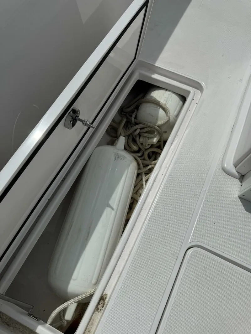 Slide: The Image of Storage compartment on 2022 Streamline Center Console boat with ropes and fenders. - 11