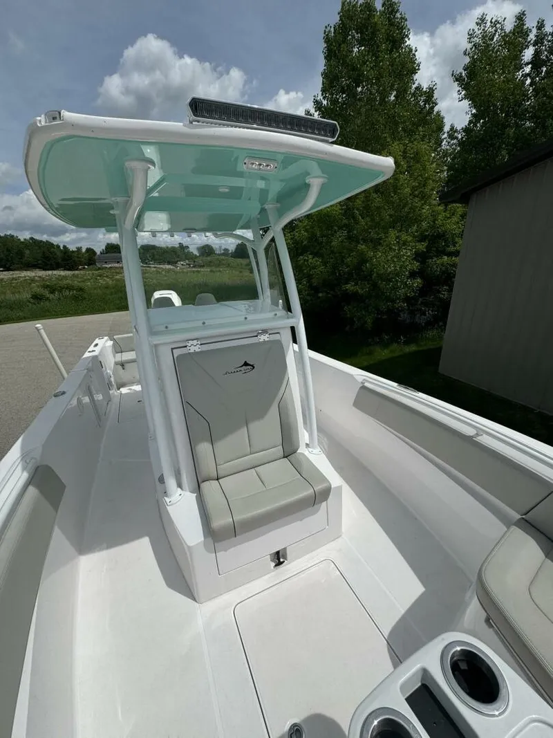 Slide: The Image of 2022 Streamline Center Console boat with sleek design and modern features, docked outdoors. - 17