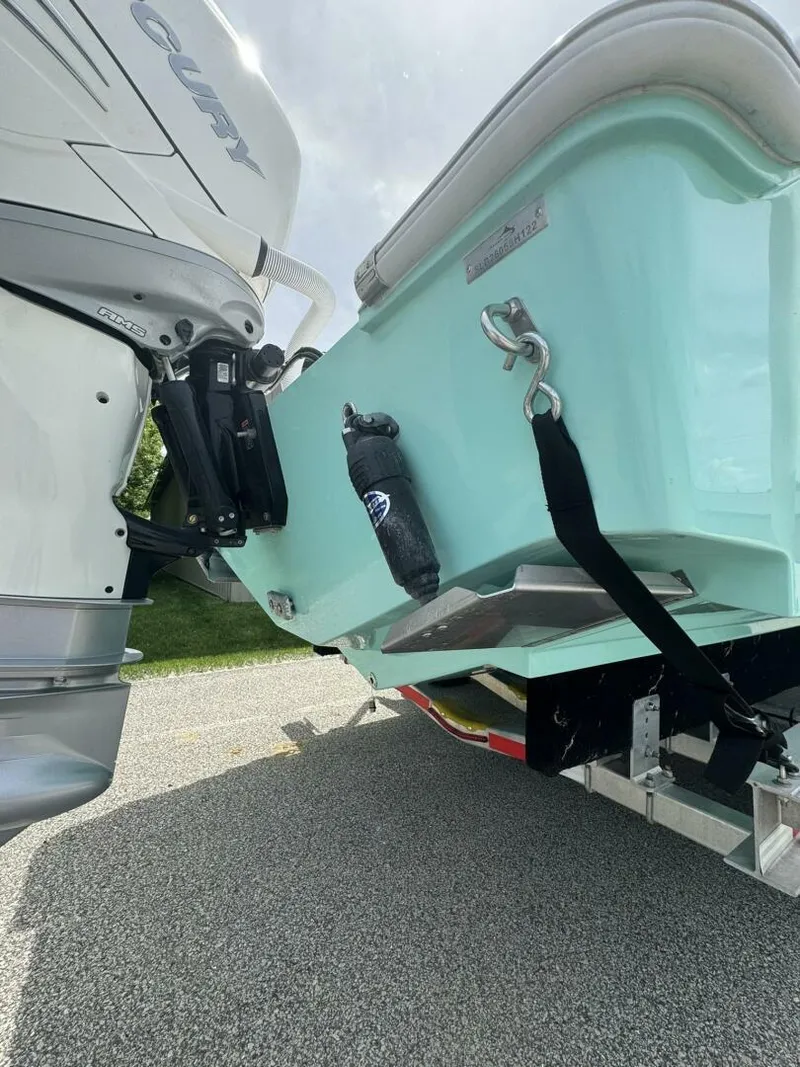 Slide: The Image of 2022 Streamline Center Console boat on trailer, featuring outboard motor and teal hull. - 2
