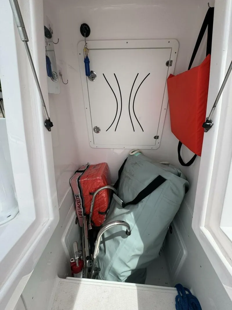 Slide: The Image of 2022 Streamline Center Console storage area with life jackets and equipment. - 20