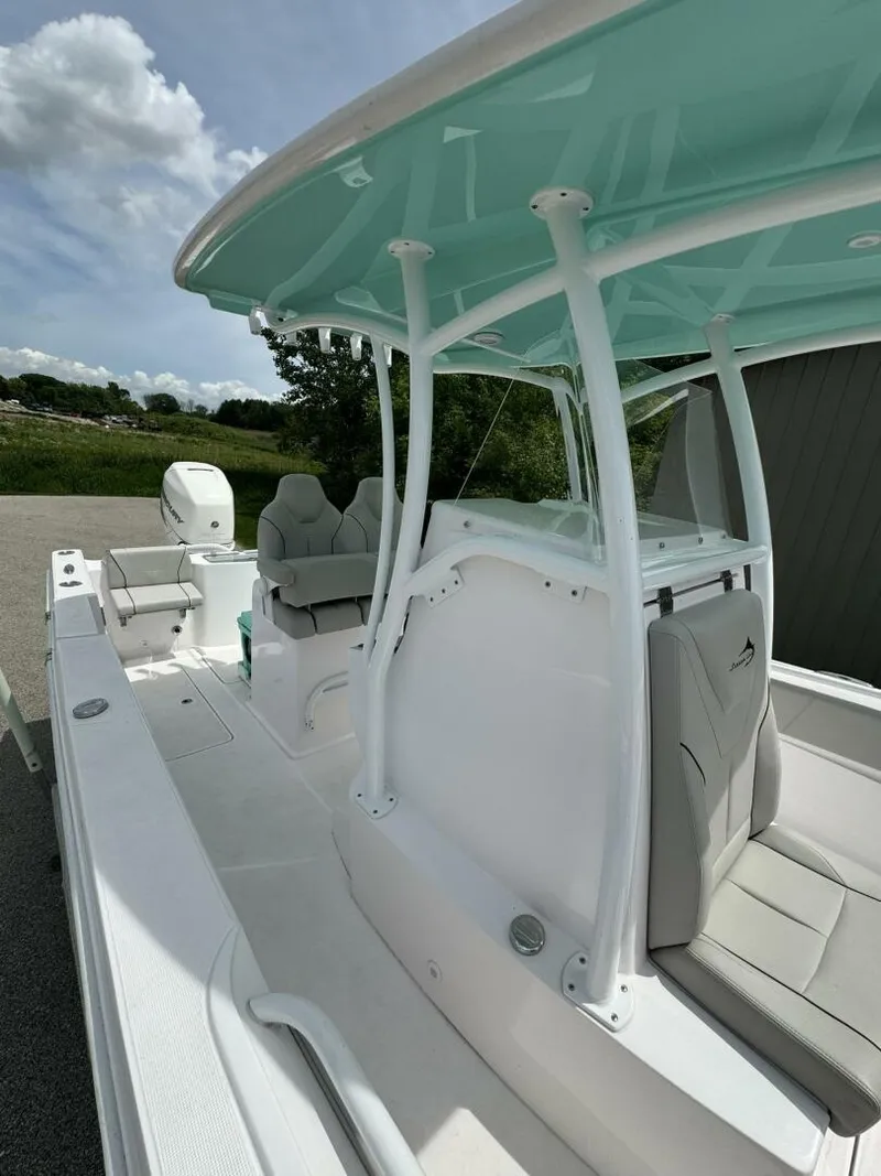 Slide: The Image of 2022 Streamline Center Console boat with sleek design and spacious seating under a blue canopy. - 21