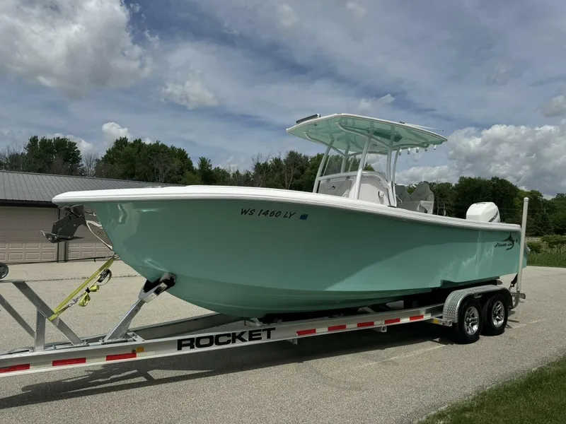 Slide: The Image of 2022 Streamline Center Console boat on trailer under cloudy sky. - 23