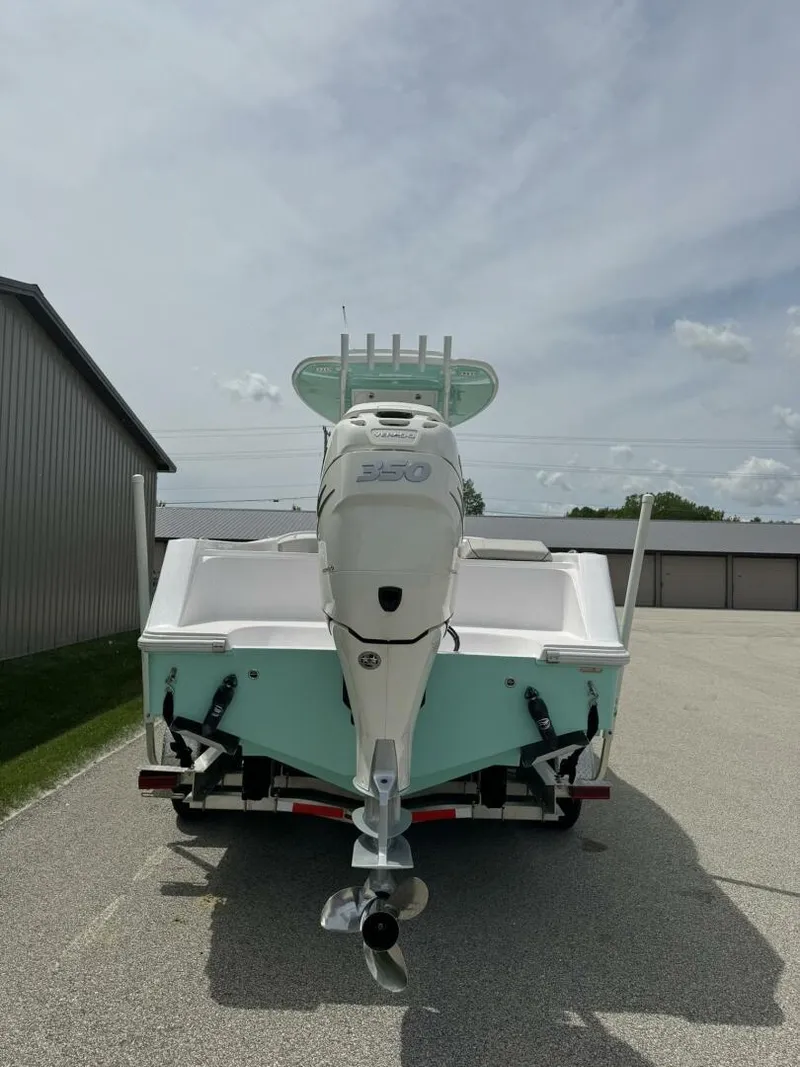 Slide: The Image of 2022 Streamline Center Console boat with powerful outboard motor, parked outdoors. - 6