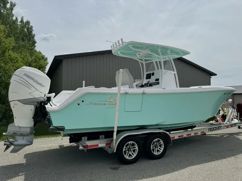 Slide: The Image of 2022 Streamline Center Console boat on trailer, light blue hull, parked outdoors. - 8