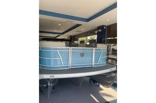 Slide: The Image of 2026 Godfrey Sweetwater 2086 CSE pontoon boat in showroom, blue exterior. - 5