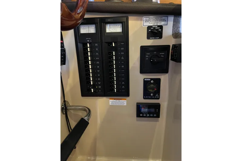 Slide: The Image of Control panel of a 2016 Ranger Tugs R-27 boat, featuring switches and gauges. - 11