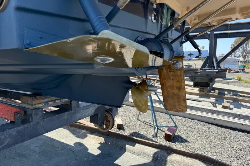 Slide: The Image of 2016 Ranger Tugs R-27 boat propeller and rudder detail in a shipyard setting. - 22