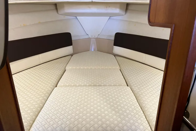 Slide: The Image of 2016 Ranger Tugs R-27 interior cabin with cushioned sleeping area. - 31
