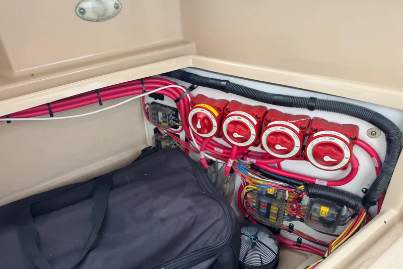Slide: The Image of Electrical panel of a 2016 Ranger Tugs R-27 boat with red switches and wiring. - 37
