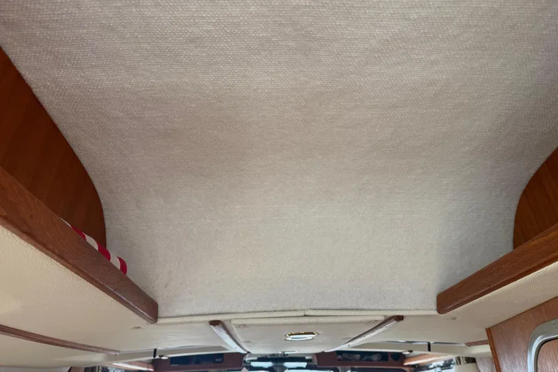 Slide: The Image of Interior ceiling of 2016 Ranger Tugs R-27 boat with wooden accents. - 42