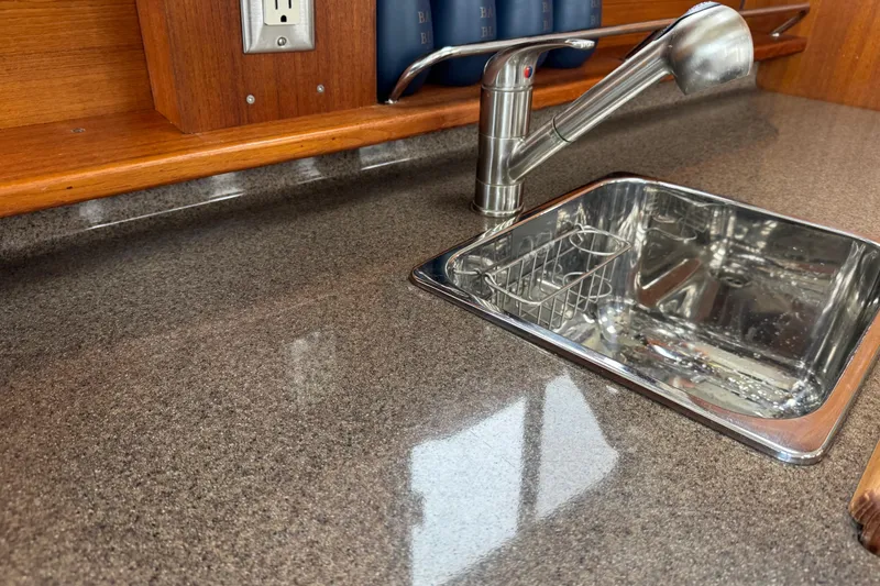 Slide: The Image of Stainless steel sink and faucet in 2016 Ranger Tugs R-27 boat kitchen. - 48
