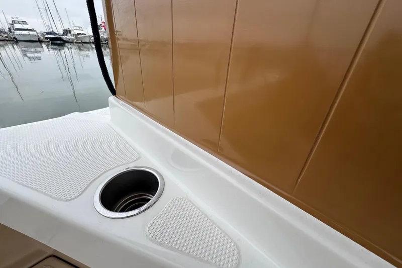 Slide: The Image of 2016 Ranger Tugs R-27 boat deck with cup holder, docked at marina. - 52