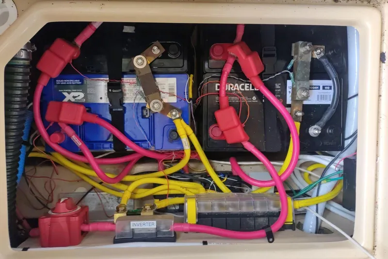 Slide: The Image of Battery compartment of 2016 Ranger Tugs R-27 with wiring and inverter connections. - 8