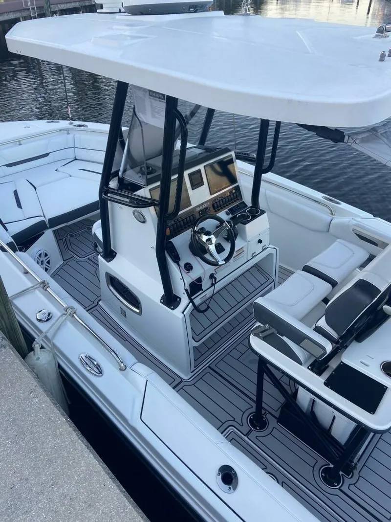 Slide: The Image of 2021 Blackfin 252 boat with modern helm, docked at marina. - 4