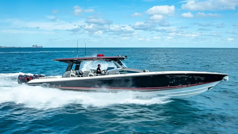 The Image of 2023 Nor-Tech 500 Sport boat cruising on open water under a clear blue sky. - 1