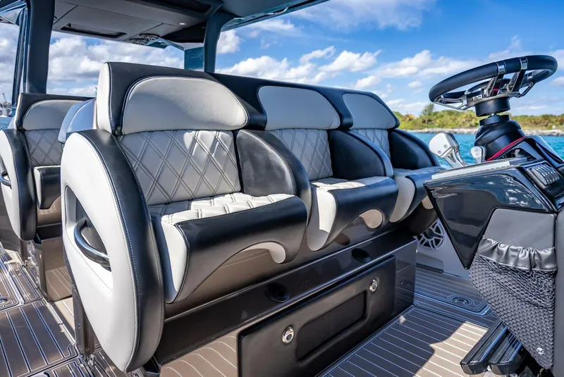 Slide: The Image of Luxurious seating and steering of 2023 Nor-Tech 500 Sport boat under clear skies. - 13