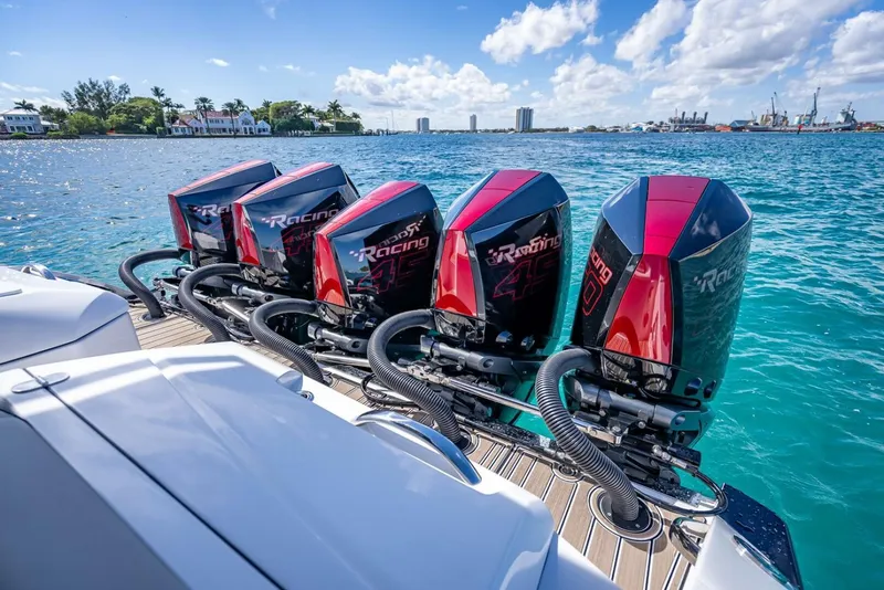 Slide: The Image of 2023 Nor-Tech 500 Sport boat with four powerful outboard engines on a sunny day. - 24