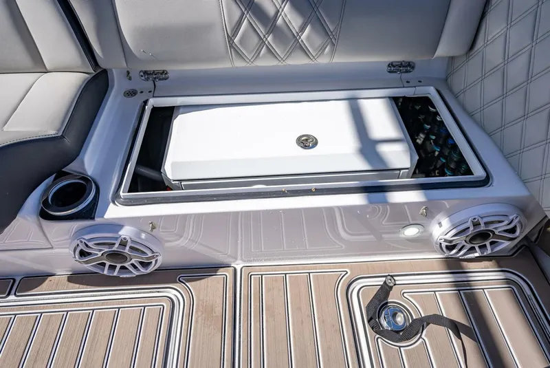 Slide: The Image of 2023 Nor-Tech 500 Sport boat interior with storage compartment and speakers. - 39
