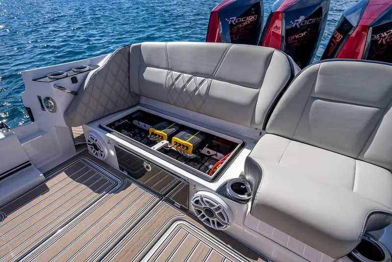 Slide: The Image of 2023 Nor-Tech 500 Sport boat interior with cushioned seating and storage compartment. - 40