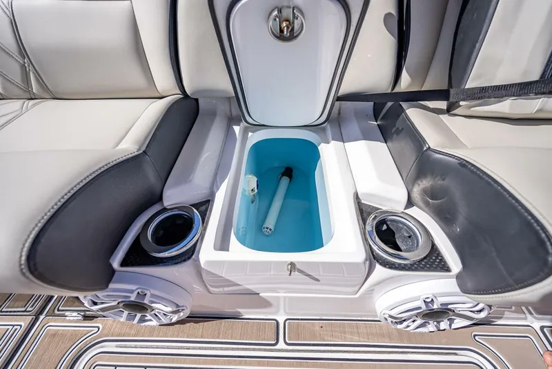 Slide: The Image of 2023 Nor-Tech 500 Sport boat interior with storage compartment and cup holders. - 42