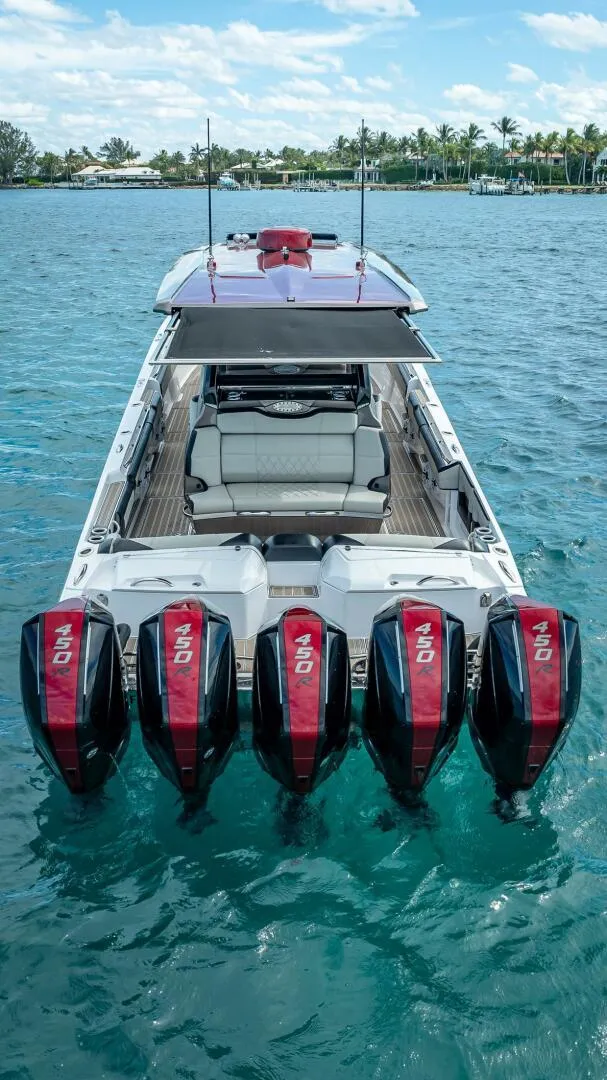 Slide: The Image of 2023 Nor-Tech 500 Sport boat with five powerful outboard engines on clear blue water. - 7