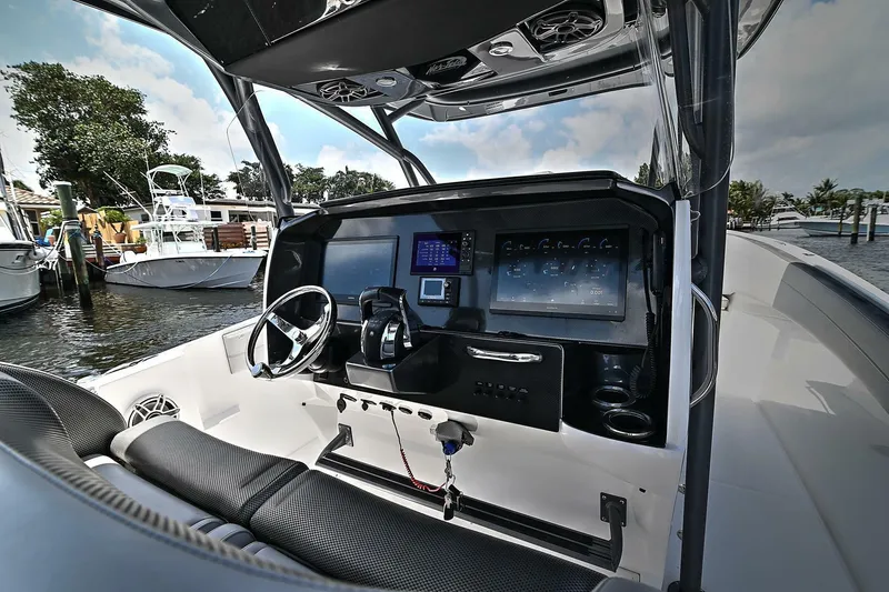 Slide: The Image of 2020 Nor-Tech 340 Sport boat cockpit with modern controls and steering wheel. - 10