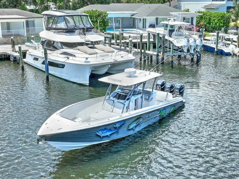 Slide: The Image of 2020 Nor-Tech 340 Sport boat docked in marina, featuring sleek design and powerful engines. - 17