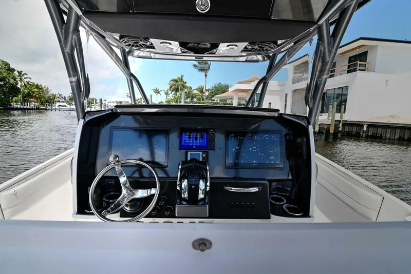 Slide: The Image of 2020 Nor-Tech 340 Sport boat dashboard with modern controls and waterfront view. - 22