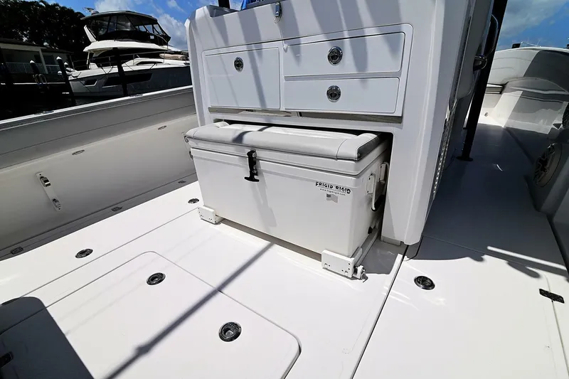 Slide: The Image of 2020 Nor-Tech 340 Sport boat interior with storage and cooler on deck. - 24