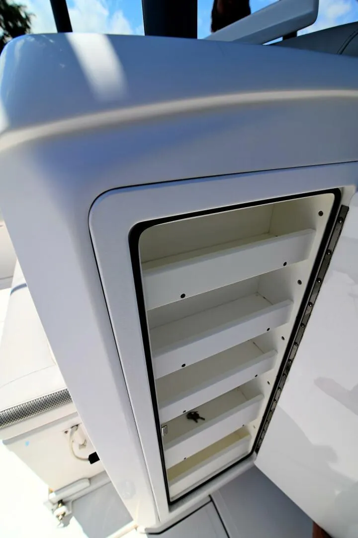 Slide: The Image of 2020 Nor-Tech 340 Sport boat storage compartment with open shelves, showcasing sleek design. - 25