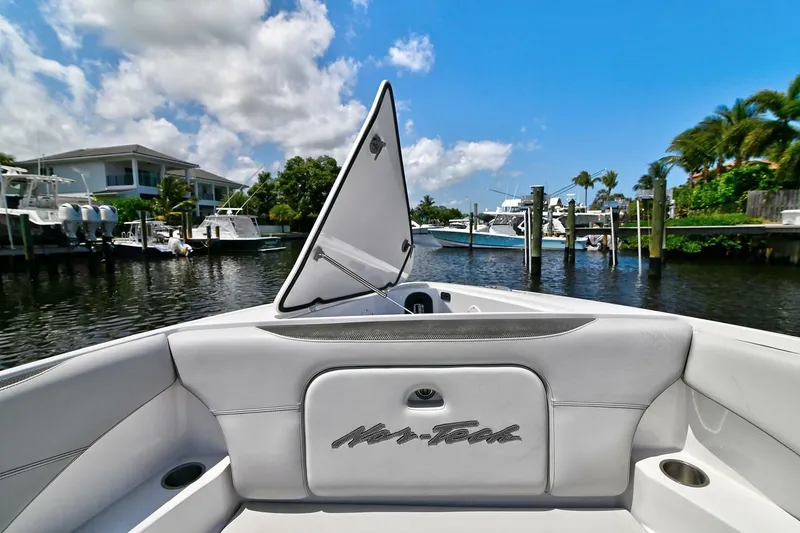 Slide: The Image of 2020 Nor-Tech 340 Sport boat docked in a scenic marina with clear skies. - 27