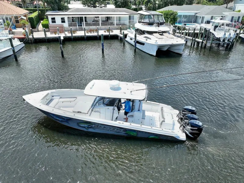 Slide: The Image of 2020 Nor-Tech 340 Sport boat on water near docks and waterfront homes. - 3