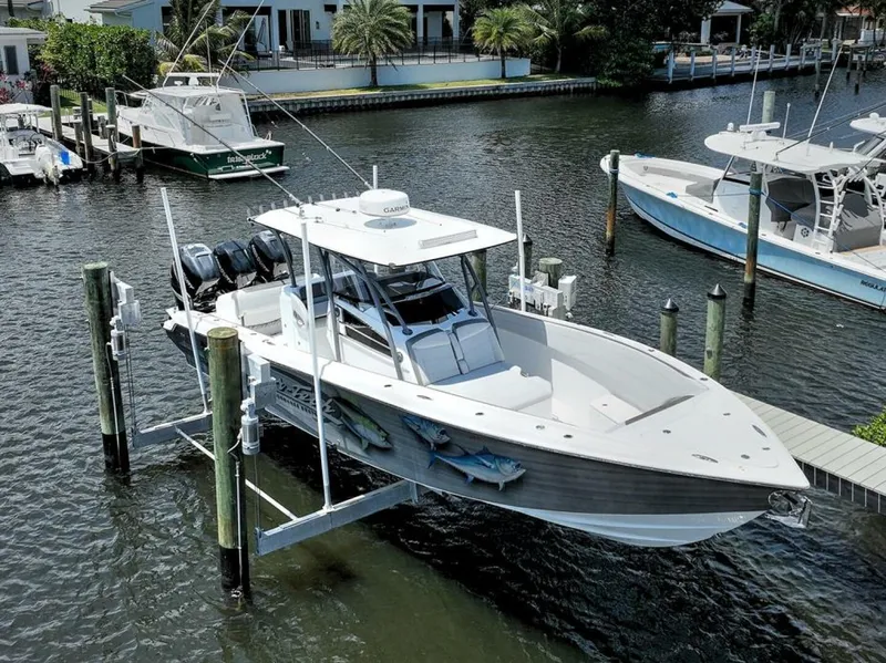 Slide: The Image of 2020 Nor-Tech 340 Sport boat docked on lift in marina. - 37