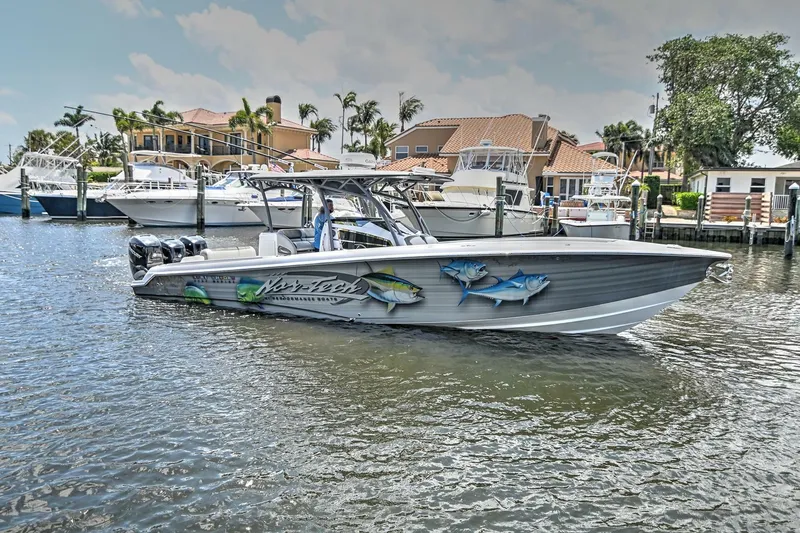 Slide: The Image of 2020 Nor-Tech 340 Sport boat docked in a scenic marina setting. - 5