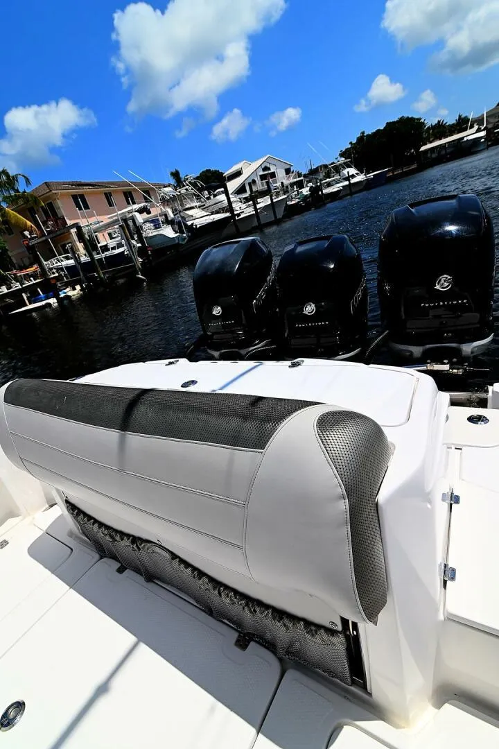 Slide: The Image of 2020 Nor-Tech 340 Sport boat with triple Mercury outboard engines docked at marina. - 9