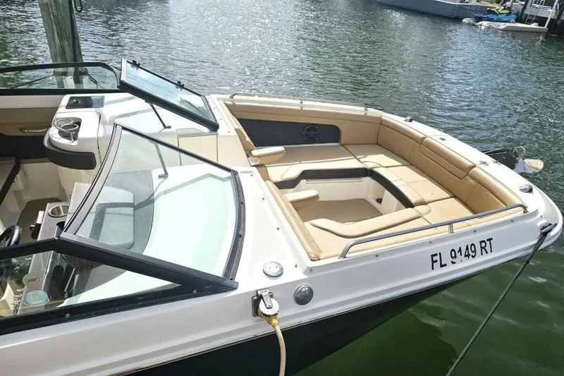Slide: The Image of 2018 Sea Ray SDX 290 Outboard boat with tan seating, docked on calm water. - 12