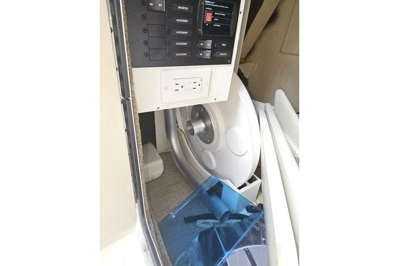 Slide: The Image of 2018 Sea Ray SDX 290 Outboard interior control panel and storage area. - 16