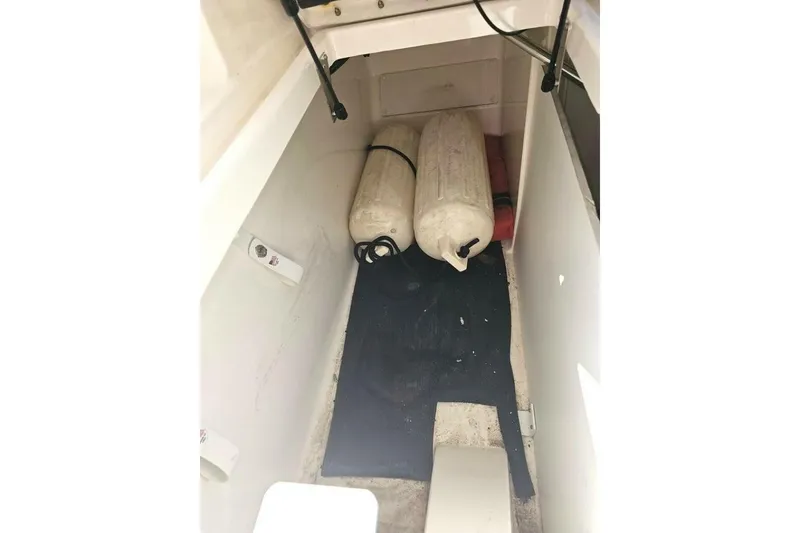 Slide: The Image of Storage compartment of 2018 Sea Ray SDX 290 Outboard with fenders and equipment. - 18