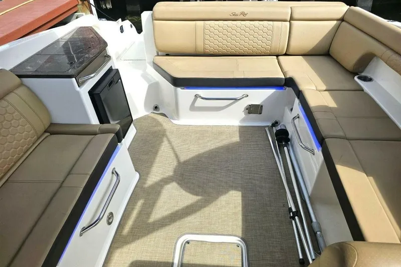 Slide: The Image of 2018 Sea Ray SDX 290 Outboard interior with beige seating and modern amenities. - 20