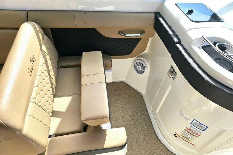Slide: The Image of 2018 Sea Ray SDX 290 Outboard interior with tan seating and modern design. - 22