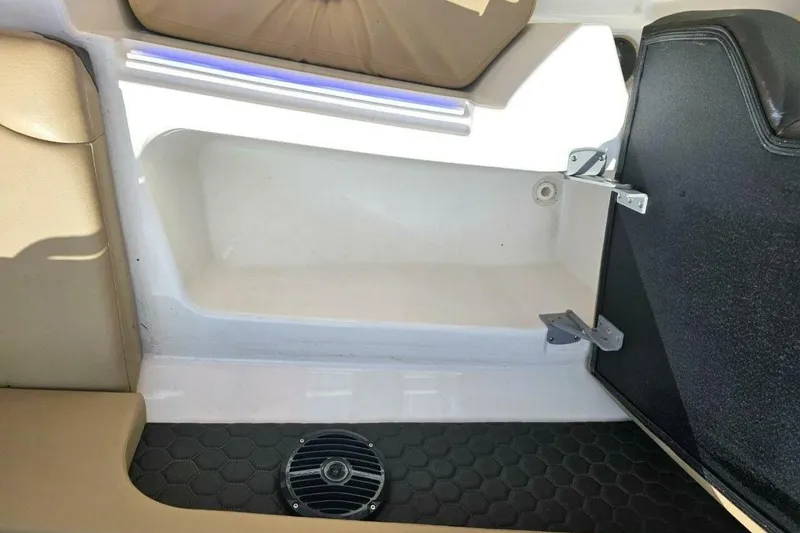 Slide: The Image of 2018 Sea Ray SDX 290 Outboard interior storage compartment with speaker and seating. - 23
