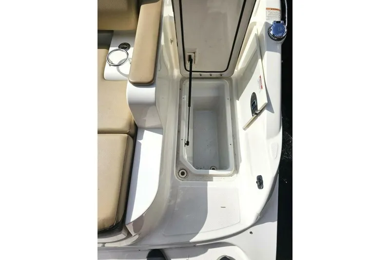 Slide: The Image of 2018 Sea Ray SDX 290 Outboard boat storage compartment with beige seating. - 27