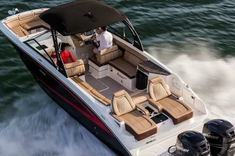Slide: The Image of 2018 Sea Ray SDX 290 Outboard cruising on water, featuring luxurious seating and dual engines. - 5