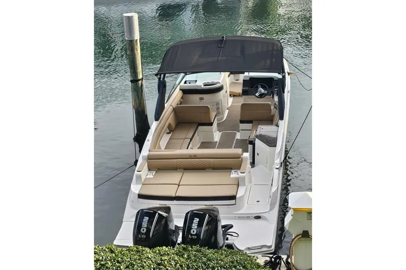 Slide: The Image of 2018 Sea Ray SDX 290 Outboard boat with dual engines, docked in calm waters. - 7