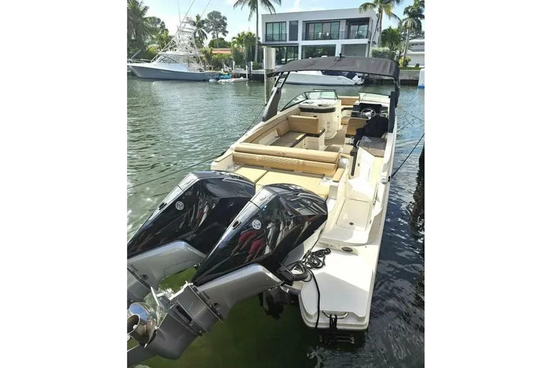 Slide: The Image of 2018 Sea Ray SDX 290 Outboard boat docked in a scenic marina setting. - 8